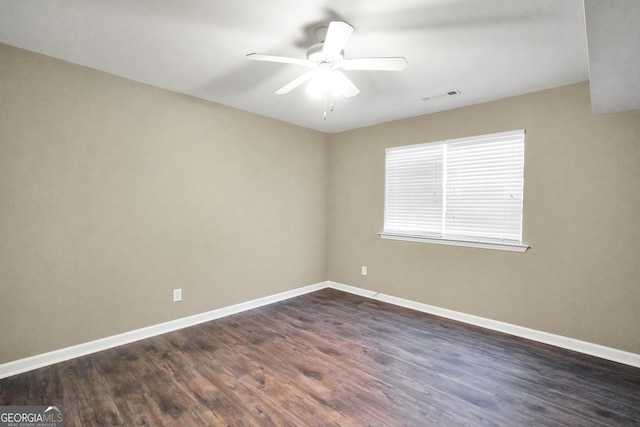 unfurnished room with ceiling fan and dark wood-type flooring