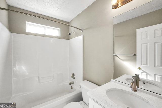 full bathroom featuring a textured ceiling, shower / bathing tub combination, vanity, and toilet