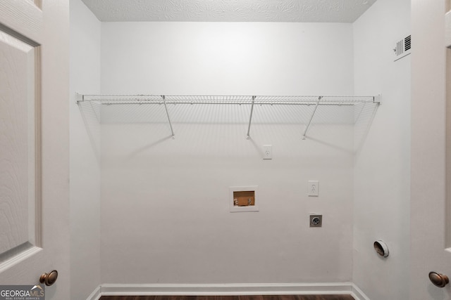 laundry room with washer hookup, a textured ceiling, and electric dryer hookup