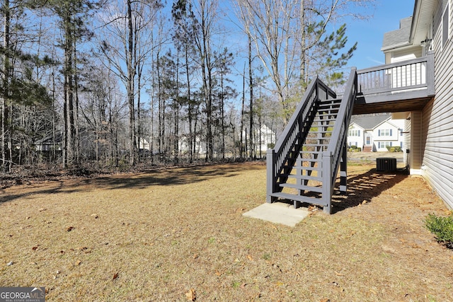 view of yard featuring central AC and a wooden deck