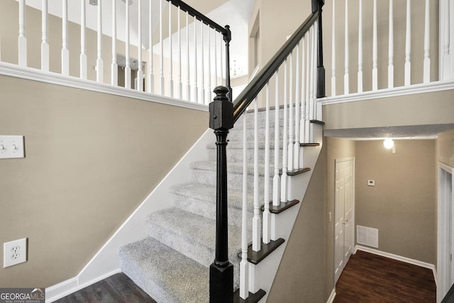 stairway with hardwood / wood-style floors