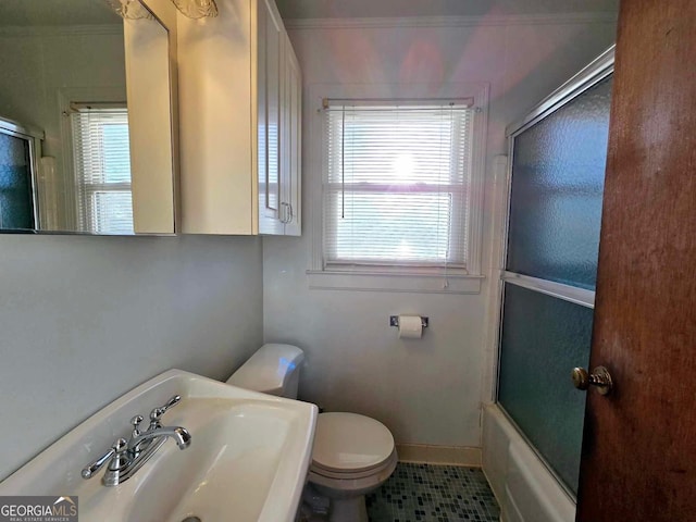 full bathroom featuring sink, shower / bath combination with glass door, toilet, and tile patterned flooring