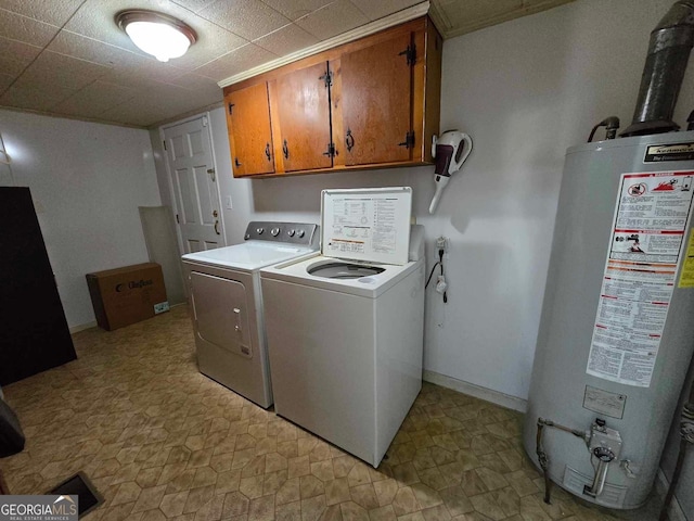 clothes washing area with water heater, cabinets, and independent washer and dryer