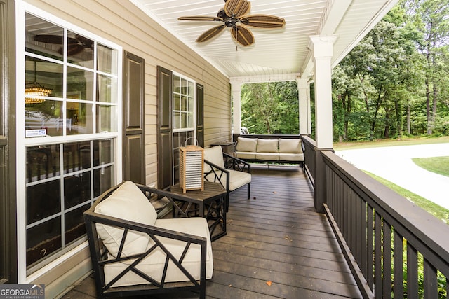 wooden terrace with ceiling fan and covered porch