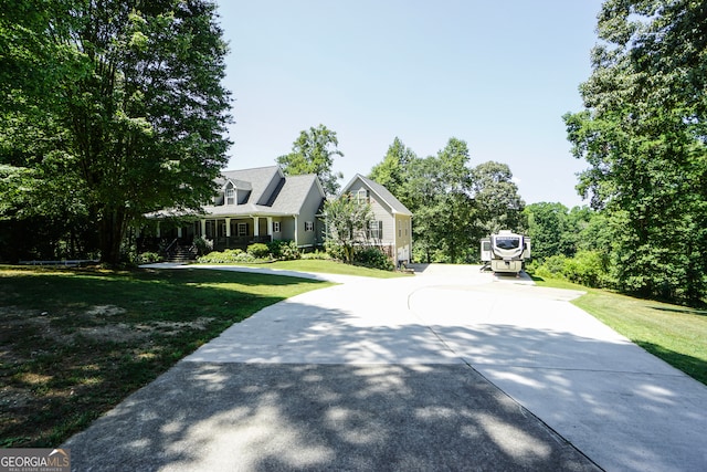 new england style home featuring a front lawn and a porch