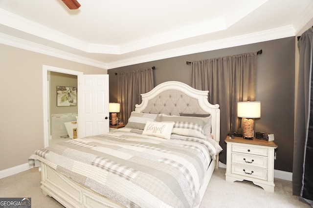 bedroom with light colored carpet, crown molding, ensuite bathroom, and a raised ceiling