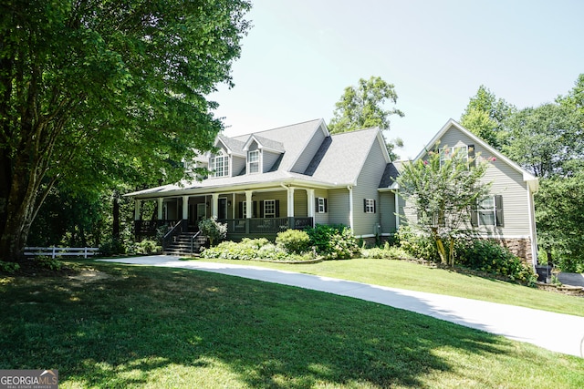 cape cod-style house with covered porch and a front yard