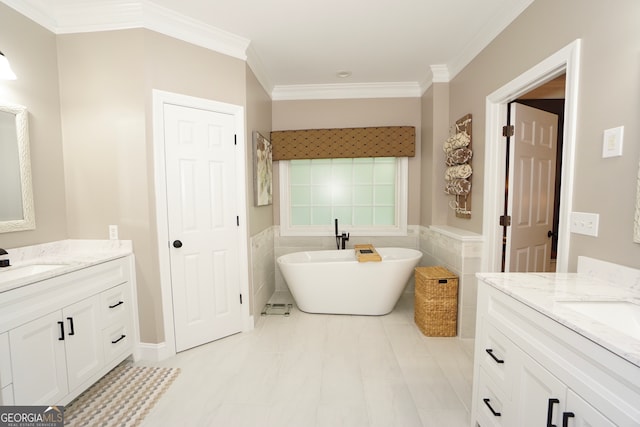 bathroom with a tub to relax in, tile walls, tile patterned floors, crown molding, and vanity