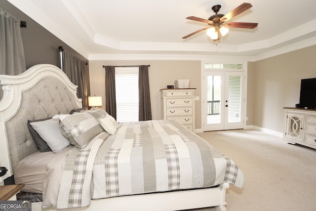 carpeted bedroom with french doors, a raised ceiling, access to outside, ornamental molding, and ceiling fan