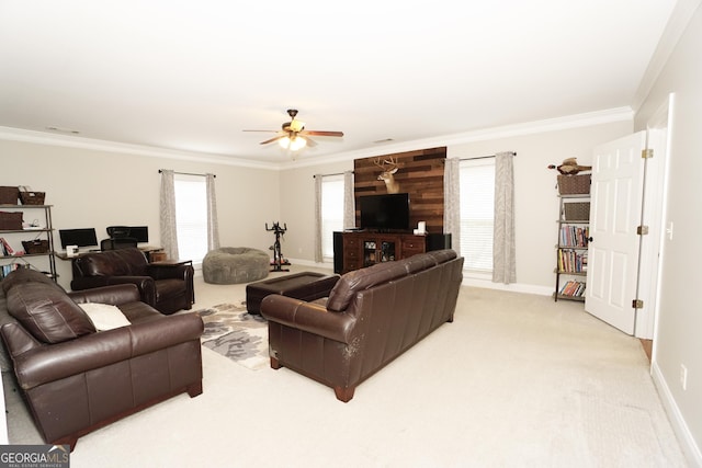 living room with ceiling fan, plenty of natural light, crown molding, and light carpet