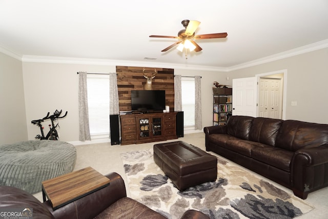 carpeted living room featuring ceiling fan and ornamental molding