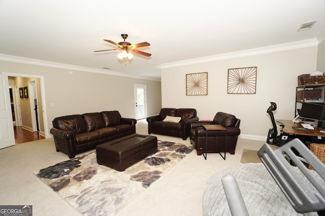 living room with ceiling fan, crown molding, and carpet flooring