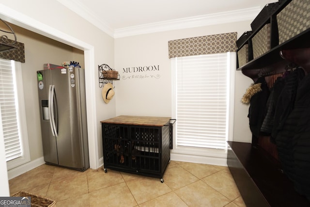 mudroom featuring light tile patterned floors and crown molding