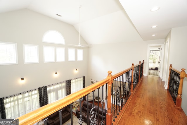 hallway featuring hardwood / wood-style flooring and lofted ceiling