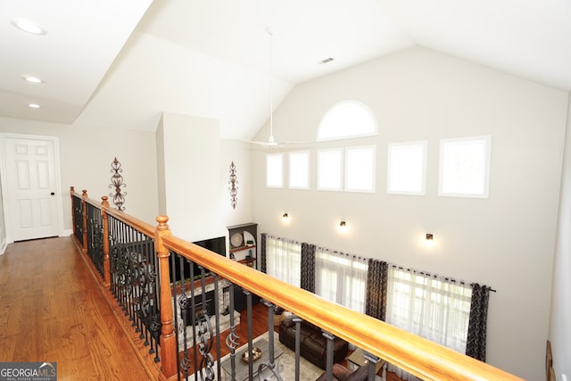 hall featuring vaulted ceiling and wood-type flooring