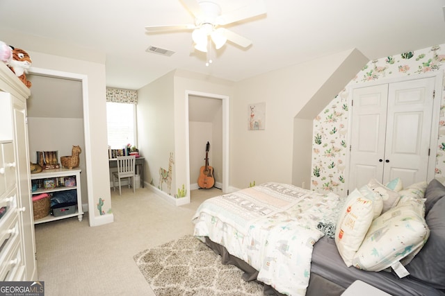 carpeted bedroom featuring ceiling fan and a closet