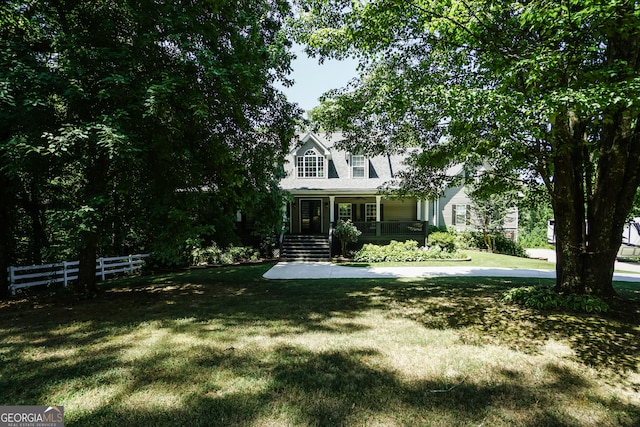 cape cod home with a front lawn and covered porch