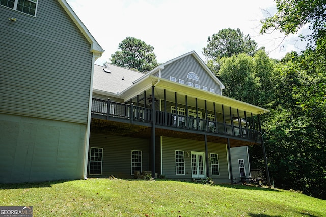 rear view of property with a yard