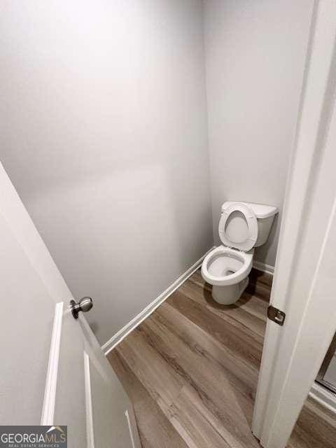 bathroom featuring toilet and hardwood / wood-style floors