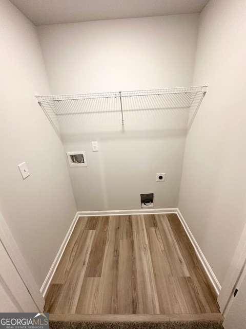 laundry room with wood-type flooring, hookup for a washing machine, and electric dryer hookup