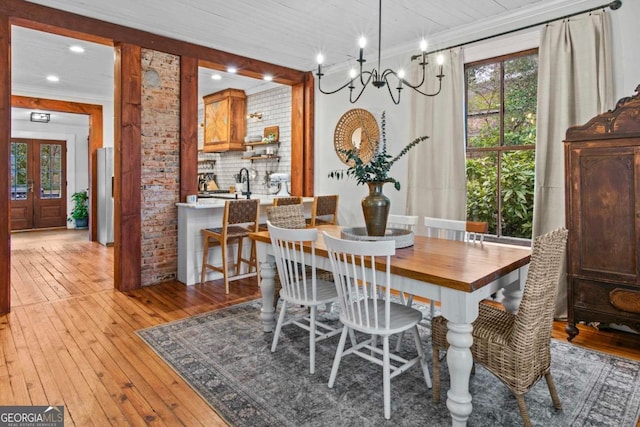 dining area featuring ornamental molding and light hardwood / wood-style floors