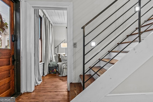 staircase with hardwood / wood-style floors