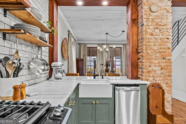 kitchen with sink, a chandelier, ornamental molding, stainless steel dishwasher, and green cabinetry