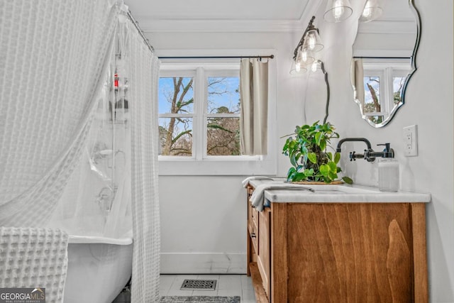 bathroom featuring sink, ornamental molding, and tile patterned floors