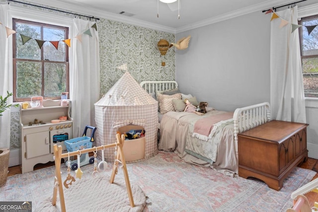 bedroom featuring crown molding, multiple windows, and light hardwood / wood-style flooring