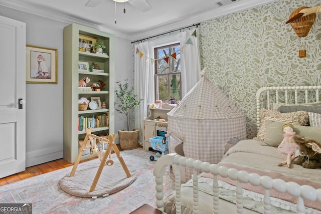 interior space featuring ceiling fan, ornamental molding, and light hardwood / wood-style flooring