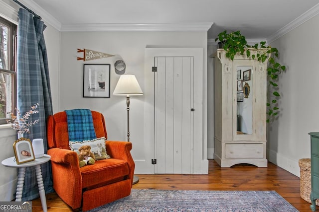 living area featuring crown molding and wood-type flooring