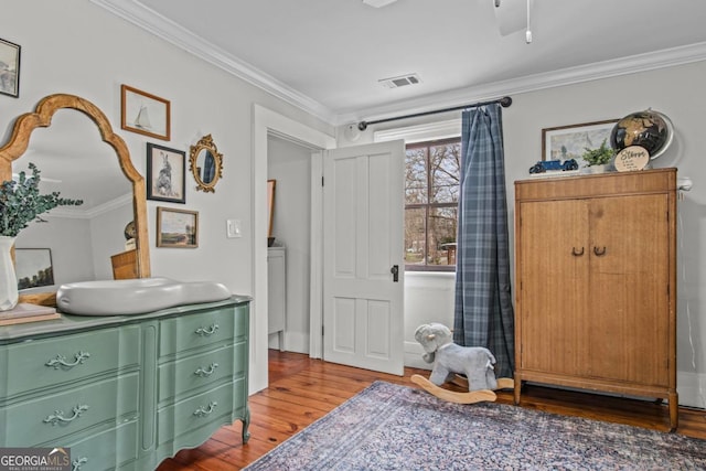 interior space with ornamental molding and wood-type flooring