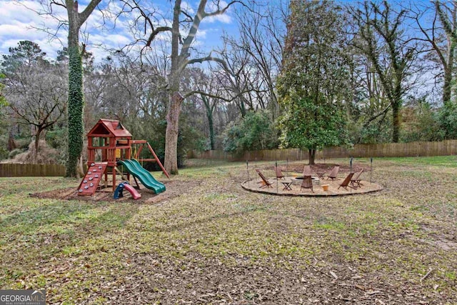 view of yard with a playground and an outdoor fire pit