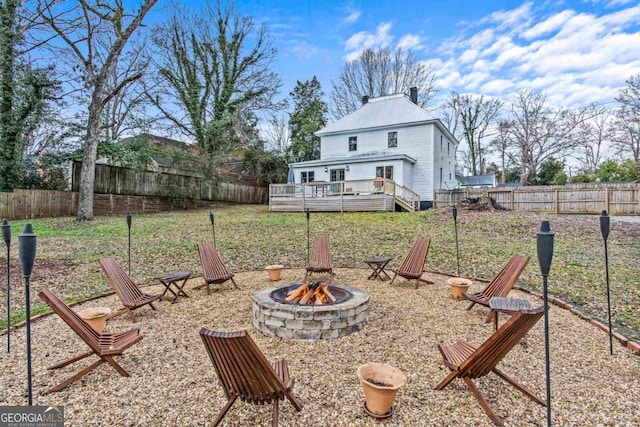 view of yard with an outdoor fire pit and a deck