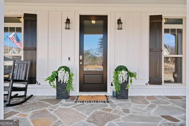 view of exterior entry with board and batten siding