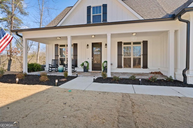 modern farmhouse style home with covered porch, board and batten siding, and a shingled roof