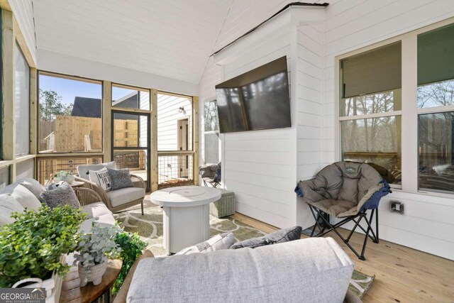 sunroom featuring vaulted ceiling