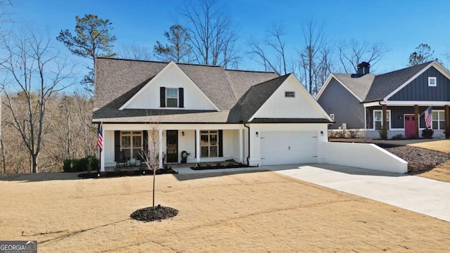 view of front of home with concrete driveway, a garage, covered porch, and roof with shingles