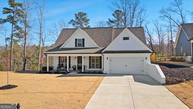 modern inspired farmhouse featuring roof with shingles, an attached garage, covered porch, concrete driveway, and board and batten siding