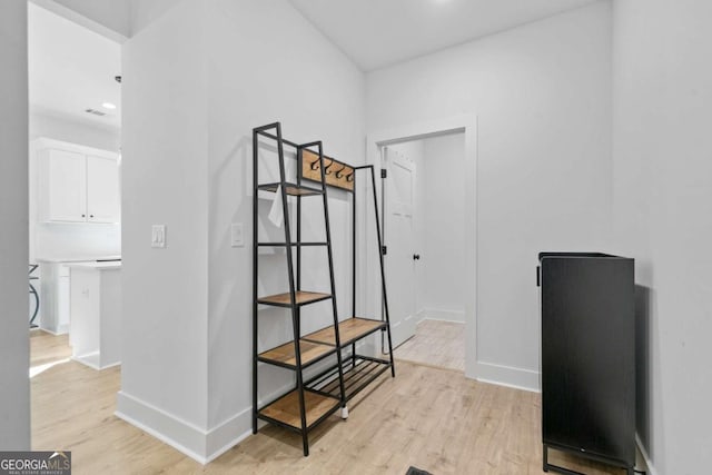 interior space featuring baseboards and wood finished floors