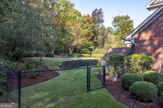 view of gate featuring a lawn