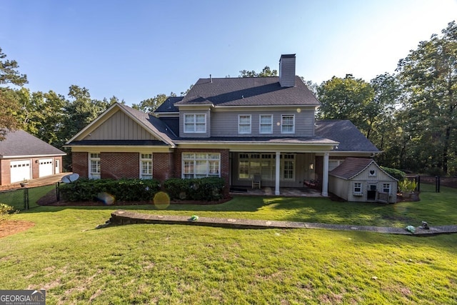 rear view of house featuring a lawn