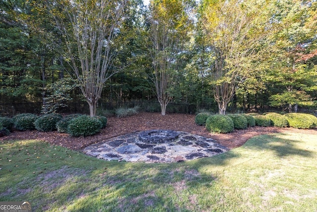 view of yard with a fire pit