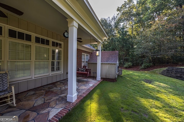 view of yard with a shed and a patio