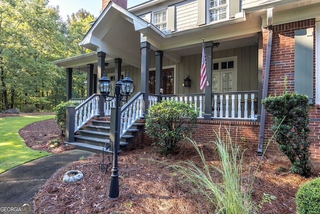 view of exterior entry featuring covered porch