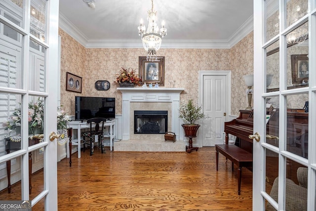 interior space with a premium fireplace, ornamental molding, and hardwood / wood-style floors