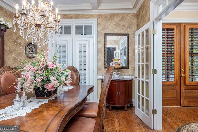 dining room featuring dark wood-type flooring, crown molding, french doors, and a notable chandelier