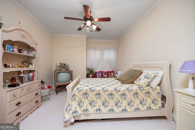 carpeted bedroom featuring a textured ceiling, ceiling fan, and crown molding