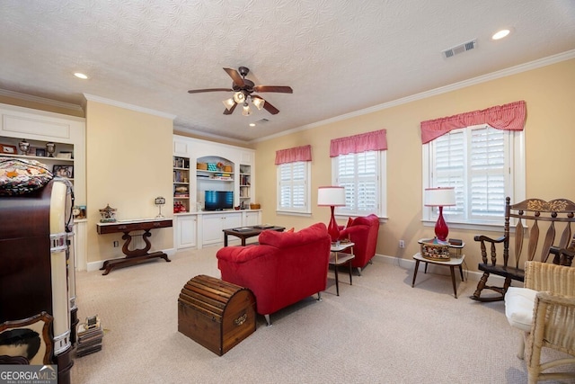 living room featuring carpet, a textured ceiling, and ornamental molding