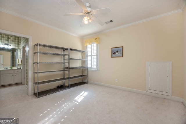 unfurnished bedroom featuring a textured ceiling, light carpet, ornamental molding, ceiling fan, and ensuite bathroom